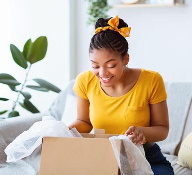 Woman opening package from online shopping in Jamaica